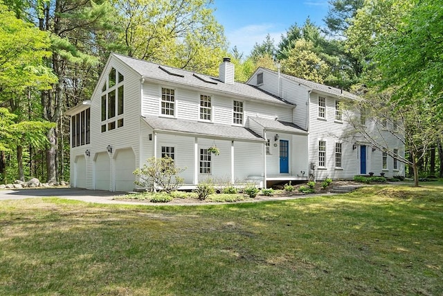 114 Hunters Ridge Rd, Concord, MA 01742 - view of front facade featuring a chimney, a garage, a front lawn, asphalt driveway, and roof with shingles