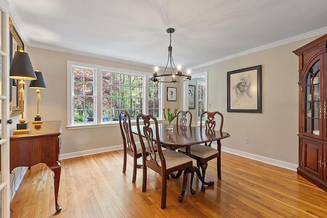 114 Hunters Ridge Rd, Concord, MA 01742 - dining area featuring a chandelier, baseboards, light wood-type flooring, and crown molding