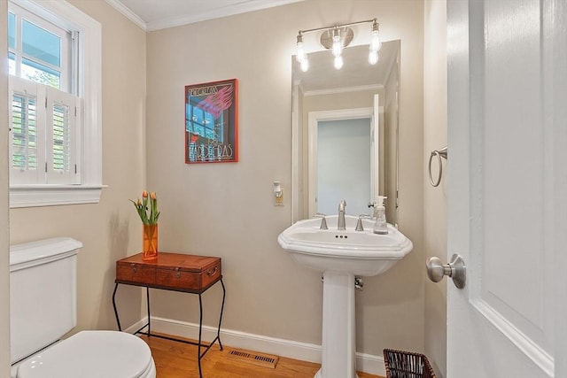 114 Hunters Ridge Rd, Concord, MA 01742 - half bathroom with toilet, crown molding, wood finished floors, and baseboards