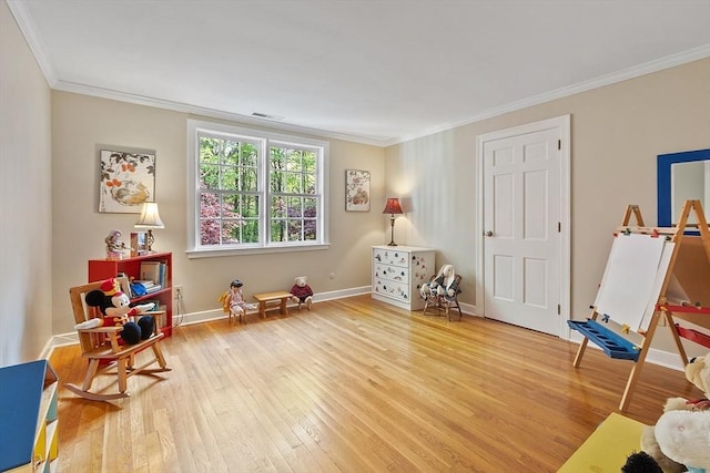 114 Hunters Ridge Rd, Concord, MA 01742 - playroom with wood finished floors, crown molding, and baseboards