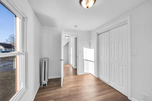 hall featuring radiator and hardwood / wood-style flooring