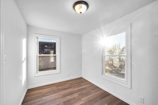 spare room featuring dark hardwood / wood-style flooring