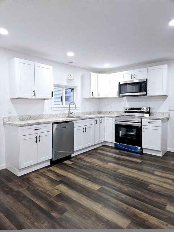 kitchen featuring sink, white cabinets, dark hardwood / wood-style floors, and appliances with stainless steel finishes