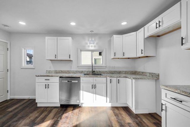 kitchen featuring white cabinets, decorative light fixtures, stainless steel dishwasher, and sink