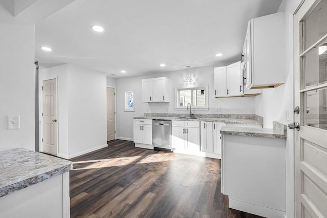 kitchen featuring white cabinets, stainless steel dishwasher, dark wood-type flooring, and sink