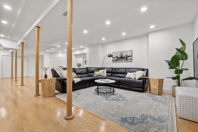 living room with ornate columns, light wood-type flooring, visible vents, and recessed lighting