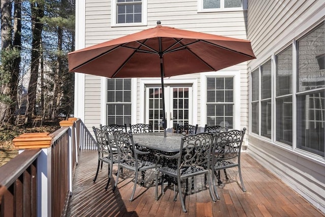 deck featuring outdoor dining space and french doors