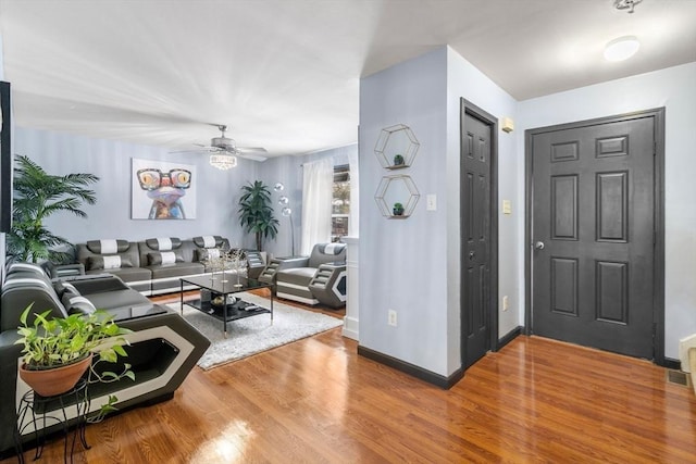 foyer with ceiling fan and wood-type flooring