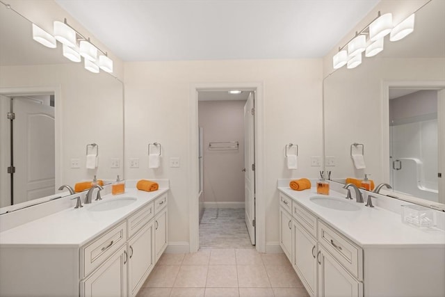 bathroom with tile patterned floors, vanity, and walk in shower