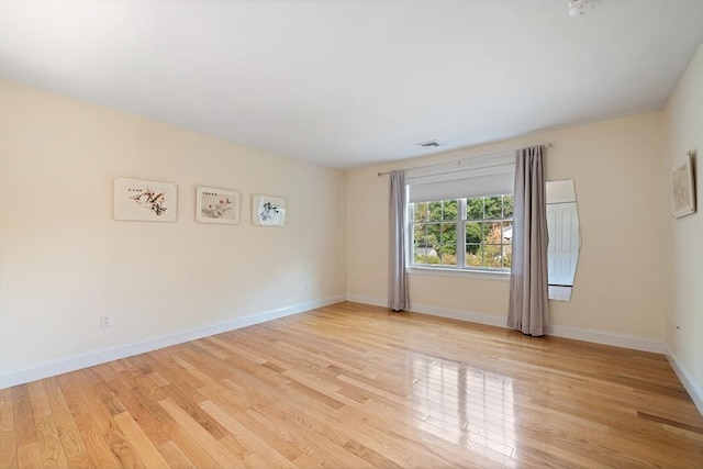 empty room with light hardwood / wood-style floors