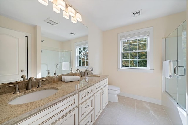 full bathroom featuring tile patterned flooring, vanity, toilet, and a wealth of natural light