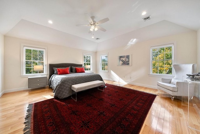 bedroom featuring light wood-type flooring, vaulted ceiling, and ceiling fan