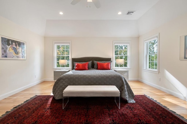 bedroom with multiple windows, ceiling fan, and light hardwood / wood-style flooring