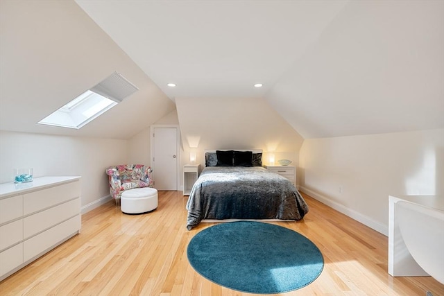 bedroom featuring lofted ceiling with skylight and light wood-type flooring