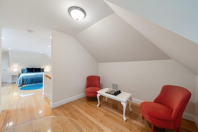 sitting room featuring wood-type flooring and lofted ceiling