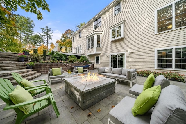 view of patio / terrace with an outdoor living space with a fire pit