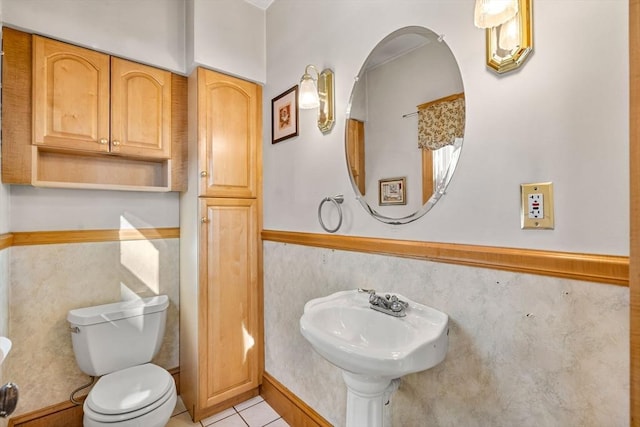 half bathroom with tile patterned flooring and toilet