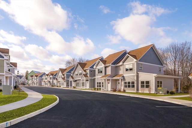 view of road featuring sidewalks, curbs, and a residential view