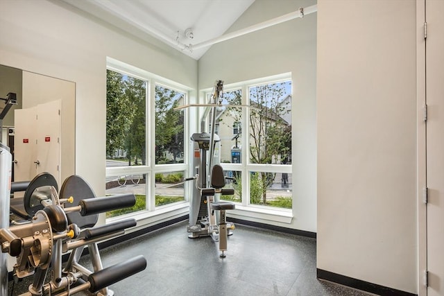 exercise area with vaulted ceiling and baseboards