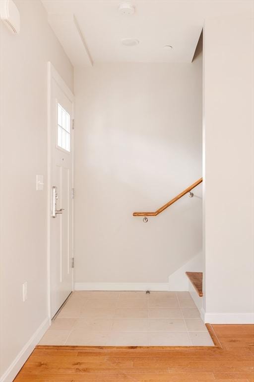 stairway with baseboards and wood finished floors