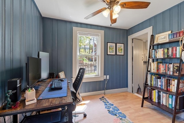 office space with light wood-type flooring, baseboards, and ceiling fan