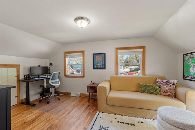 office with plenty of natural light, light wood-style floors, vaulted ceiling, and visible vents