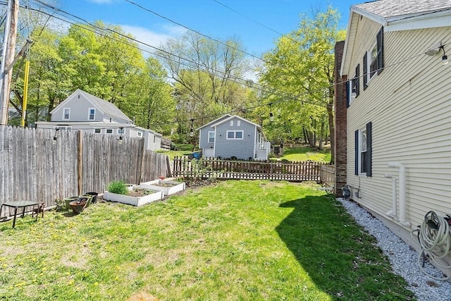 view of yard featuring a vegetable garden and a fenced backyard