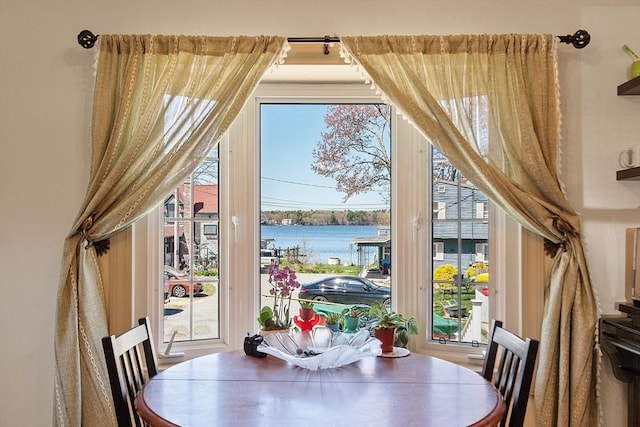 dining room featuring a water view