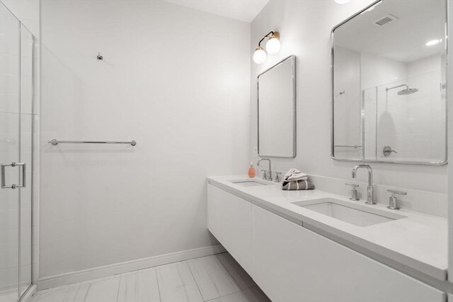 bathroom with vanity and a shower with door