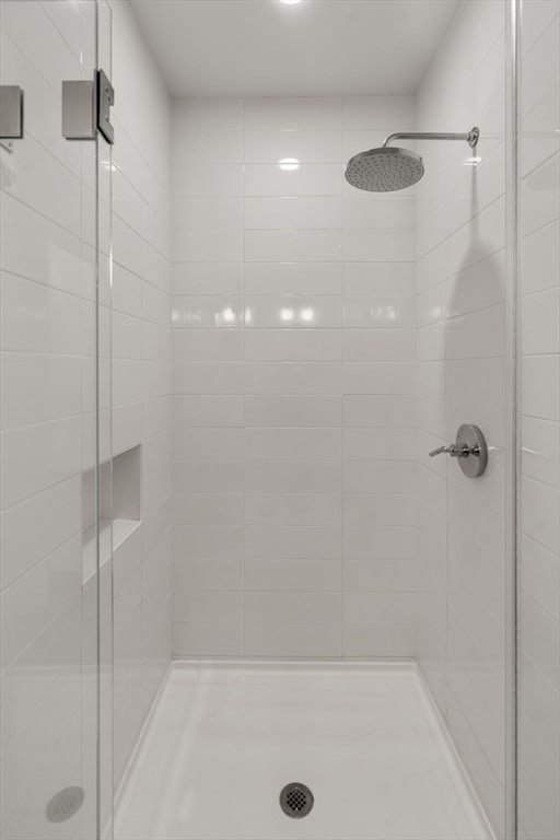 bathroom with a shower with door