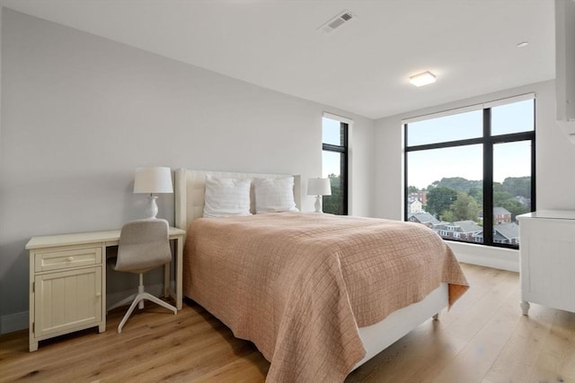 bedroom featuring light wood-type flooring and visible vents