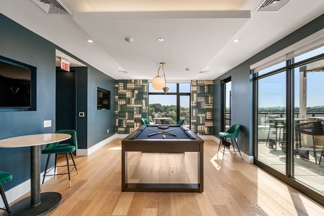 game room with pool table, expansive windows, and light wood-type flooring