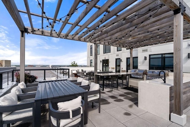 view of patio / terrace with outdoor dining space, a grill, a pergola, and area for grilling