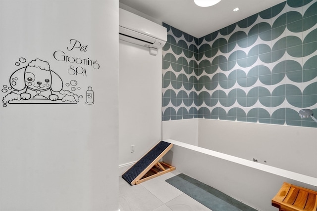 bathroom with a bathing tub, an AC wall unit, and tile patterned floors