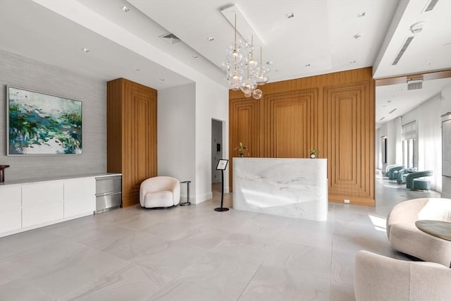 reception area featuring visible vents and a notable chandelier