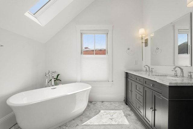 23 Union St Unit 2, Salem, MA 01970 - full bathroom featuring marble finish floors, vaulted ceiling, double vanity, a freestanding tub, and a skylight
