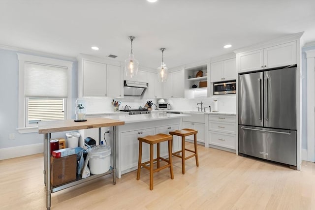 23 Union St Unit 2, Salem, MA 01970 - kitchen with stainless steel appliances, open shelves, backsplash, white cabinets, and recessed lighting