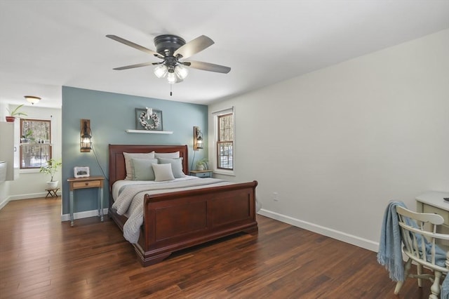 bedroom with ceiling fan, baseboards, and dark wood finished floors