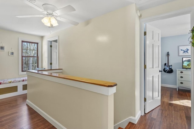 hall with baseboards and dark wood finished floors