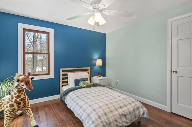 bedroom with ceiling fan, baseboards, and dark wood finished floors