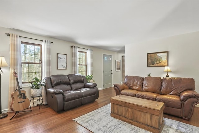 living area with baseboards and dark wood-style flooring