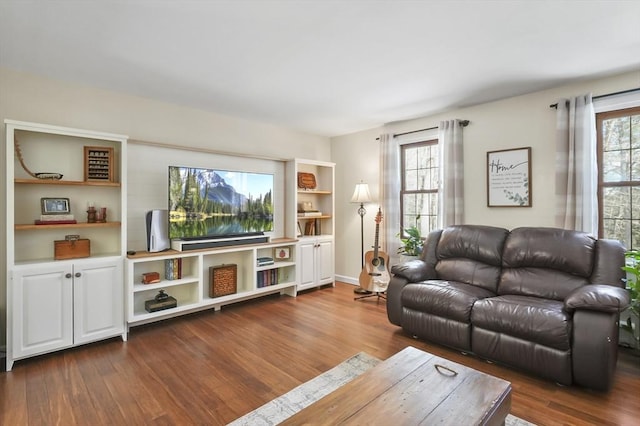 living room featuring dark wood-style floors and a wealth of natural light