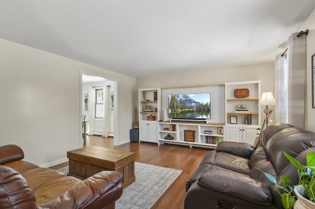 living room featuring dark wood-style floors and baseboards