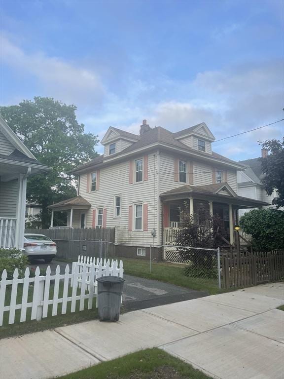 31 Bryant St, Springfield, MA 01108 - view of home's exterior with a fenced front yard, a chimney, and a porch