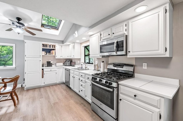17 High St, Merrimac, MA 01860 - kitchen featuring appliances with stainless steel finishes, a sink, open shelves, plenty of natural light, and lofted ceiling