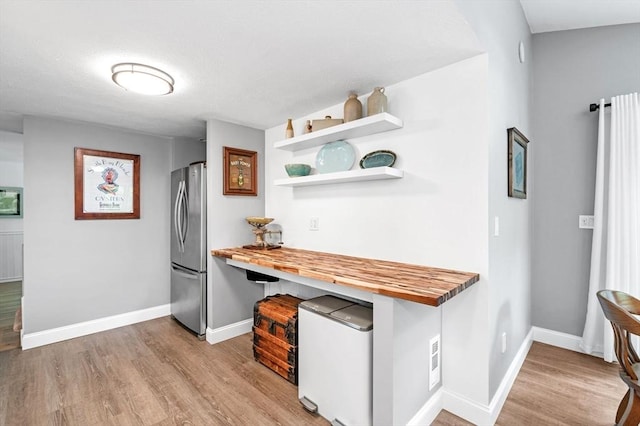 17 High St, Merrimac, MA 01860 - kitchen featuring freestanding refrigerator, butcher block countertops, open shelves, and wood finished floors