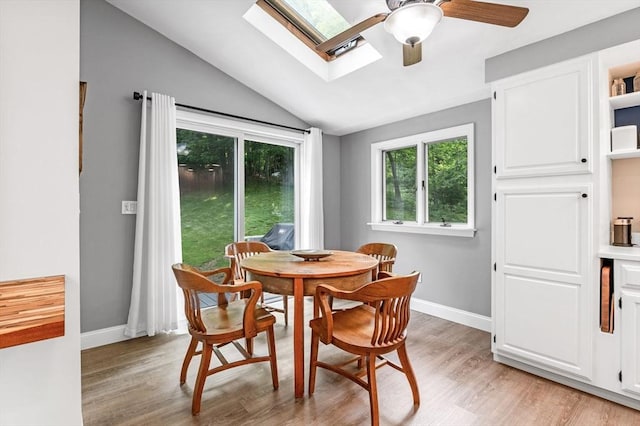 17 High St, Merrimac, MA 01860 - dining area featuring lofted ceiling, light wood finished floors, a ceiling fan, baseboards, and a skylight