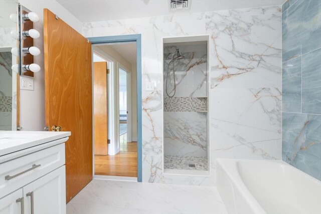 bathroom featuring vanity and plus walk in shower