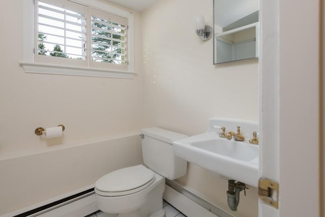 bathroom with toilet, baseboard heating, and sink