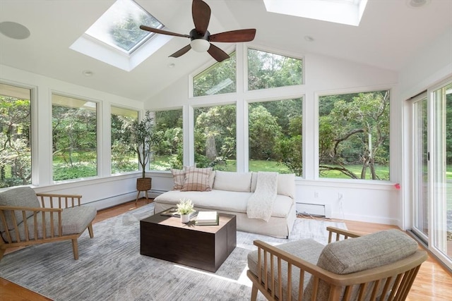 sunroom with ceiling fan and vaulted ceiling with skylight